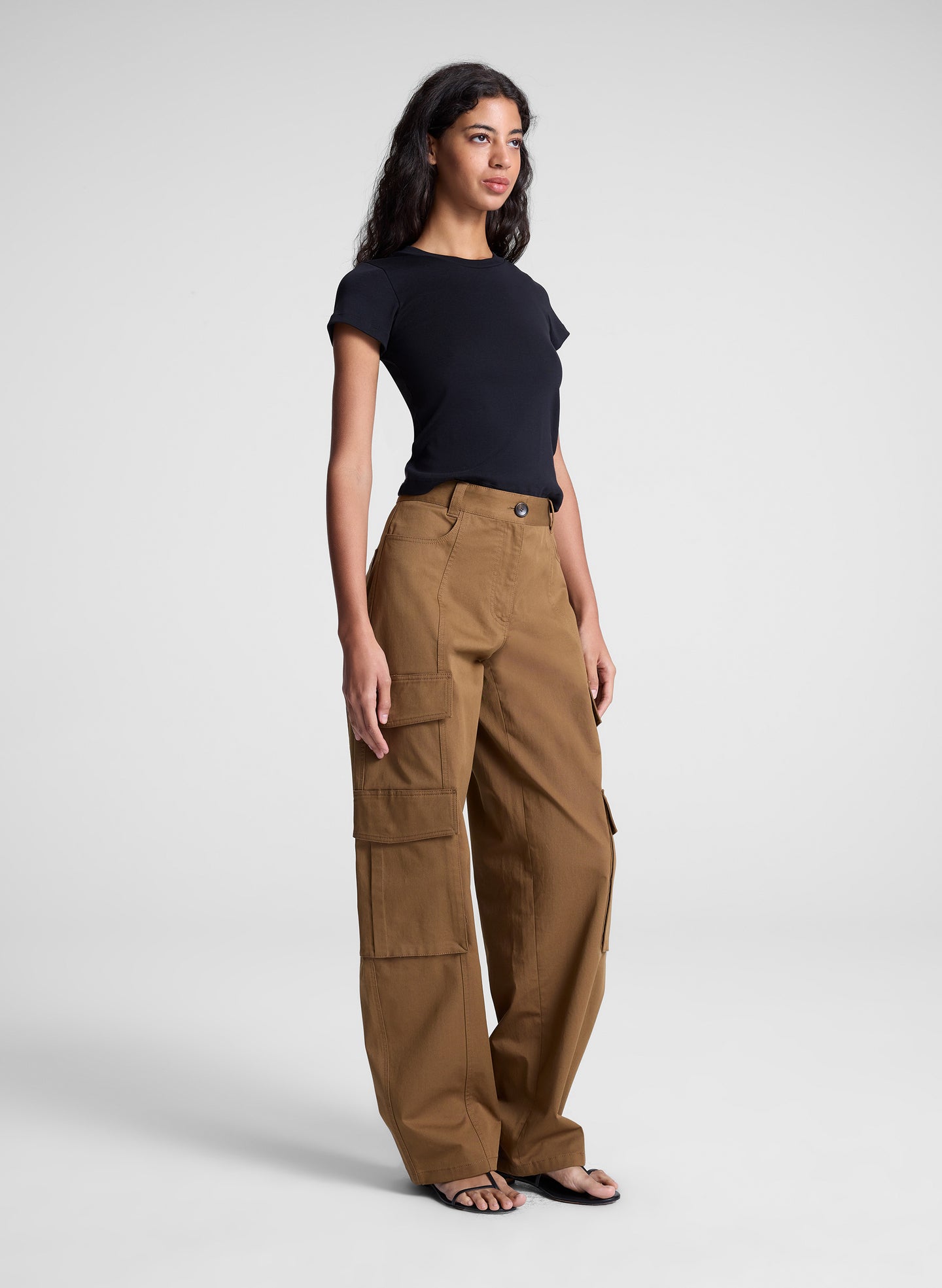 woman wearing black tee shirt and brown pants