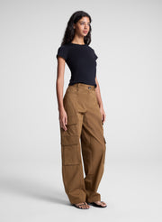 woman wearing black tee shirt and brown pants