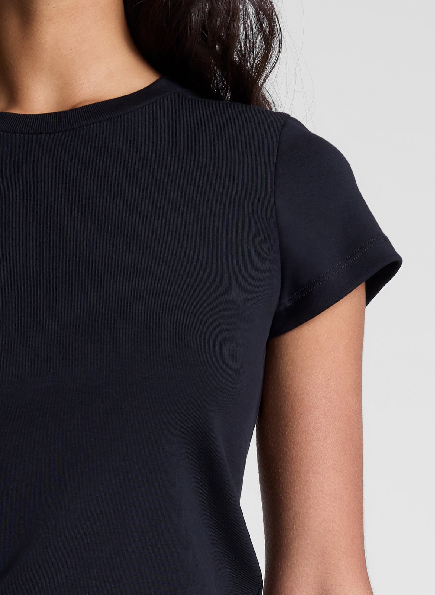 woman wearing black tee shirt and brown pants