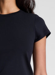 woman wearing black tee shirt and brown pants