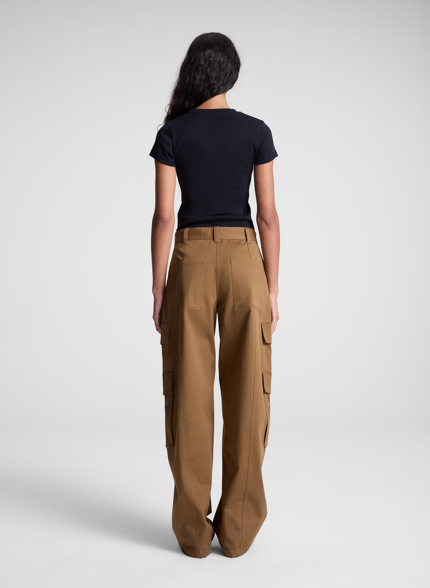 woman wearing black tee shirt and brown pants