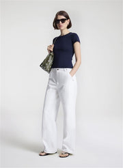 woman wearing navy blue tshirt and white denim jeans