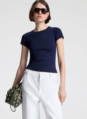 woman wearing navy blue tshirt and white denim jeans