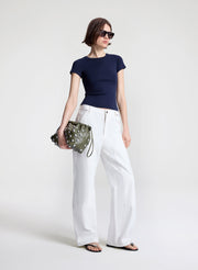 woman carrying green studded handbag