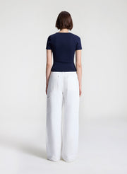 woman wearing navy blue tshirt and white denim jeans