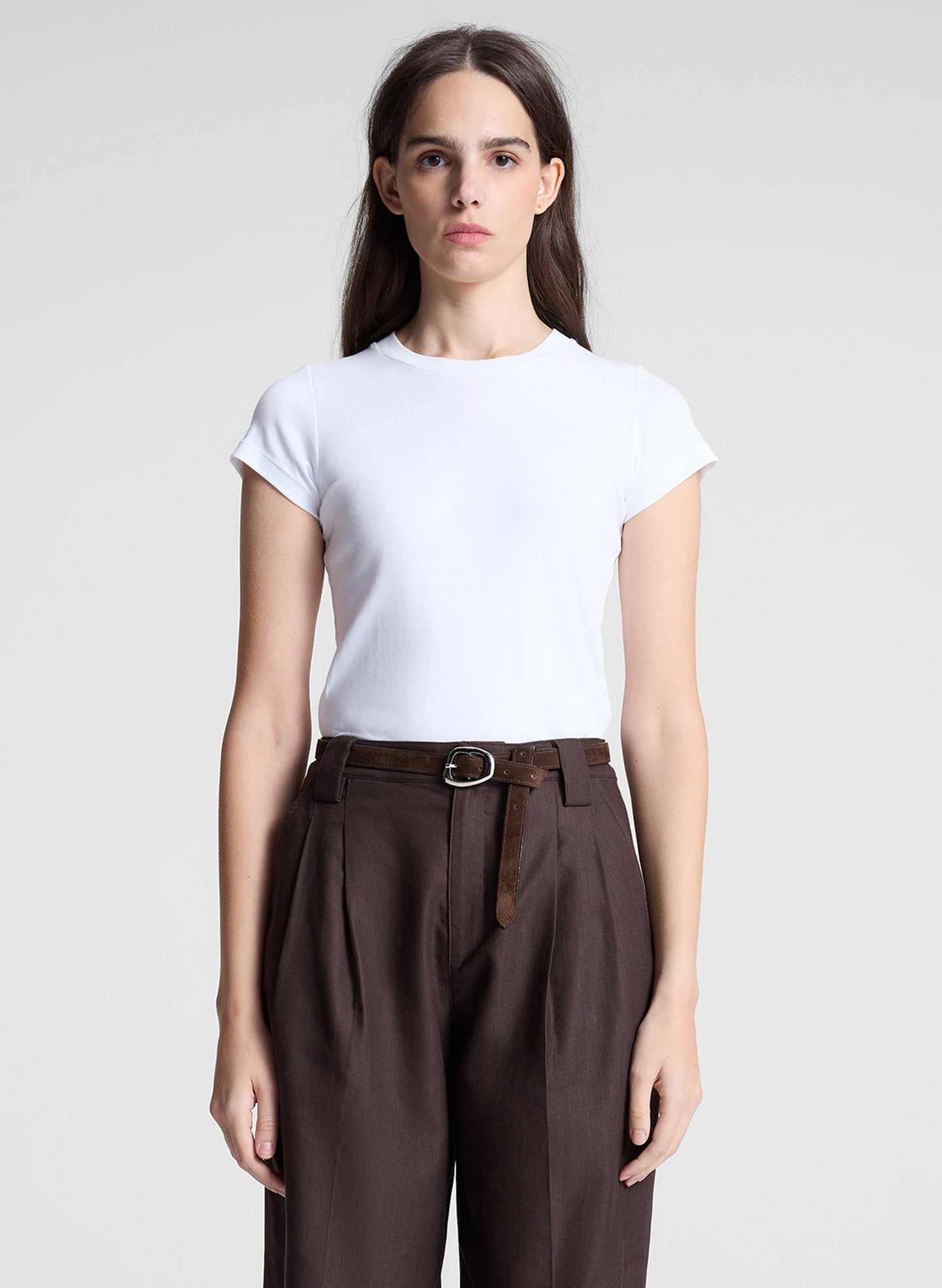 woman wearing white tshirt and brown pants