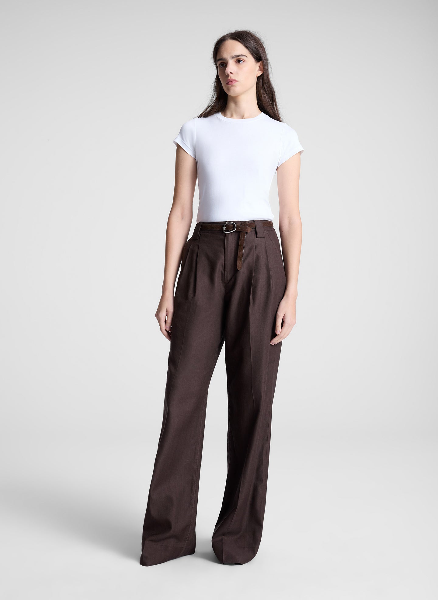 woman wearing white tshirt and brown pants