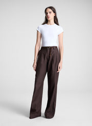 woman wearing white tshirt and brown pants