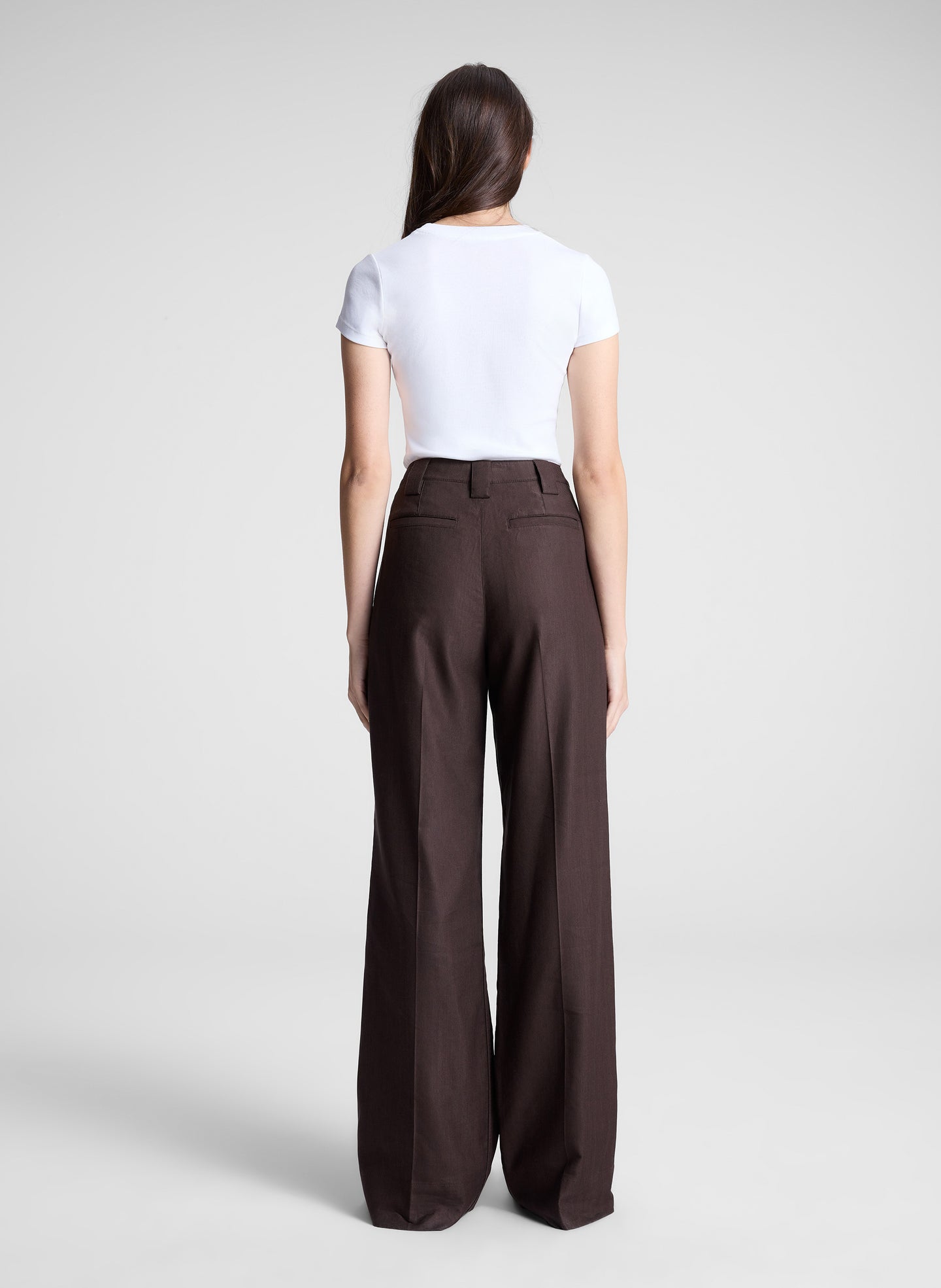 woman wearing white tshirt and brown pants