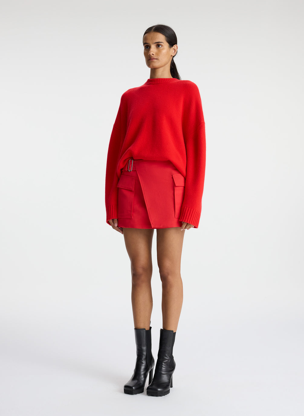 side view of woman wearing red cashmere long sleeve sweater
