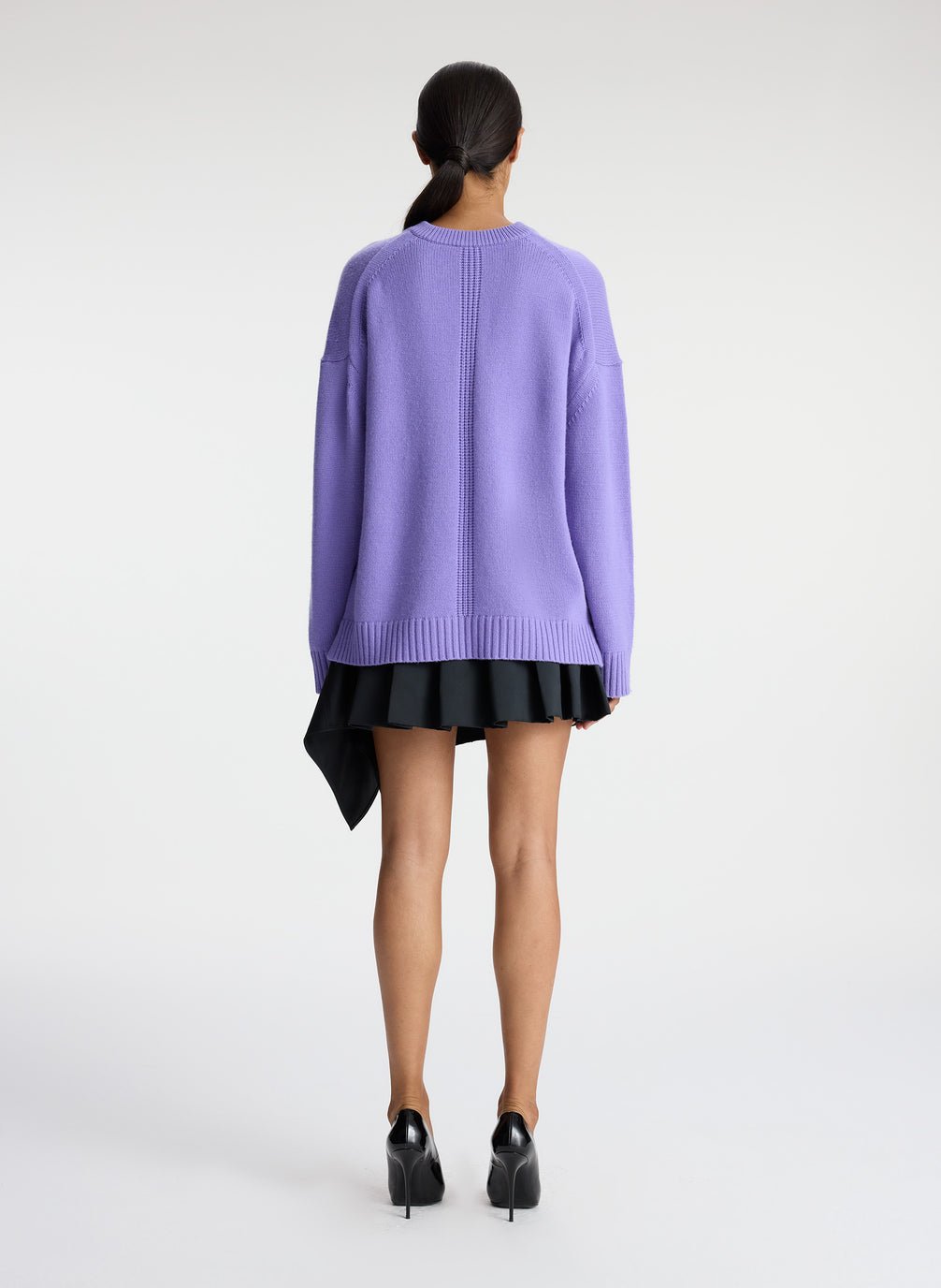 back view of woman wearing light purple cashmere long sleeve sweater