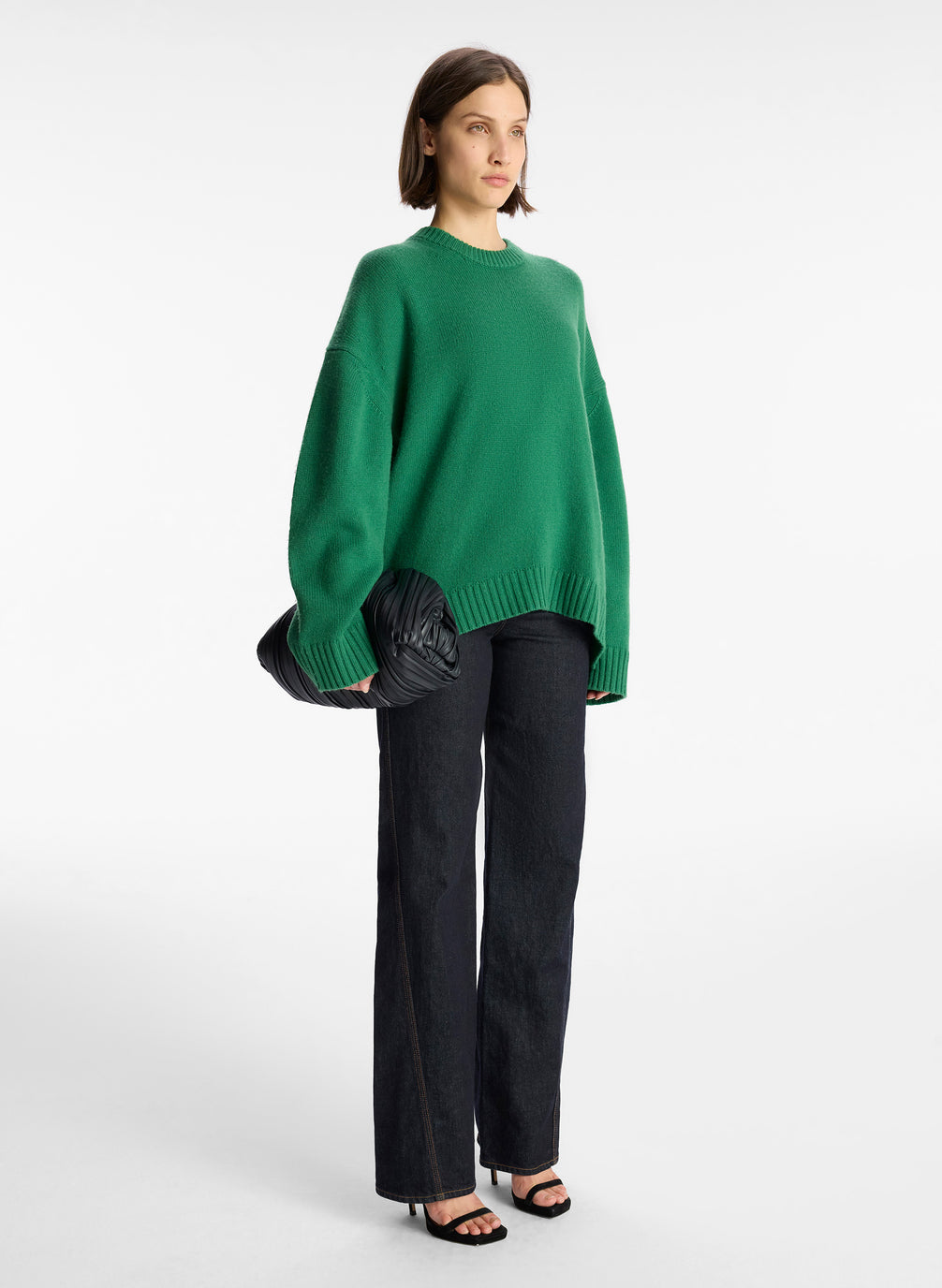 side view of woman wearing green cashmere long sleeve sweater
