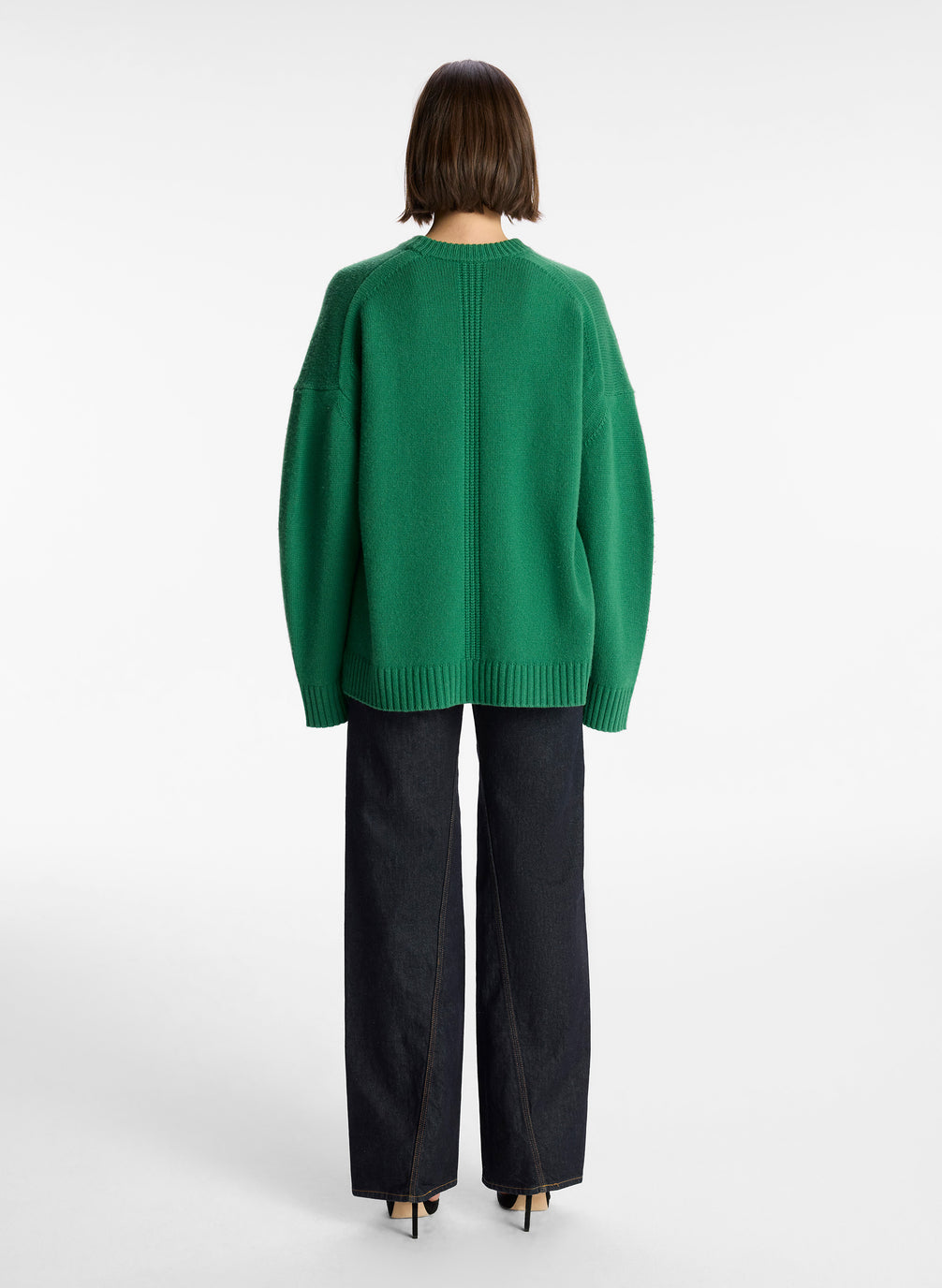 back view of woman wearing green cashmere long sleeve sweater