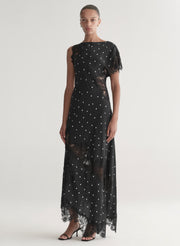 Woman wearing a black polka dot dress on a white background