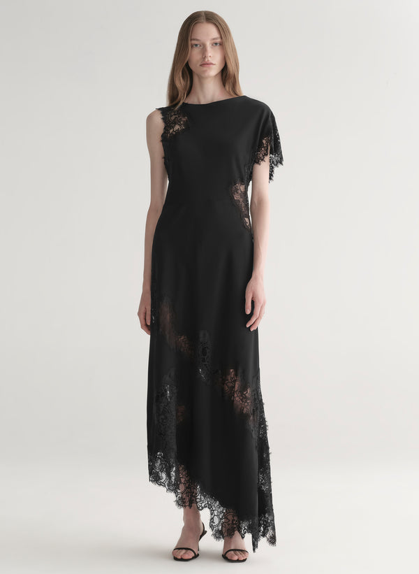 Black lace dress worn by a model on a white background