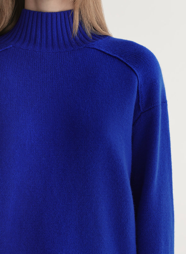 woman wearing bright blue cashmere turtleneck sweater