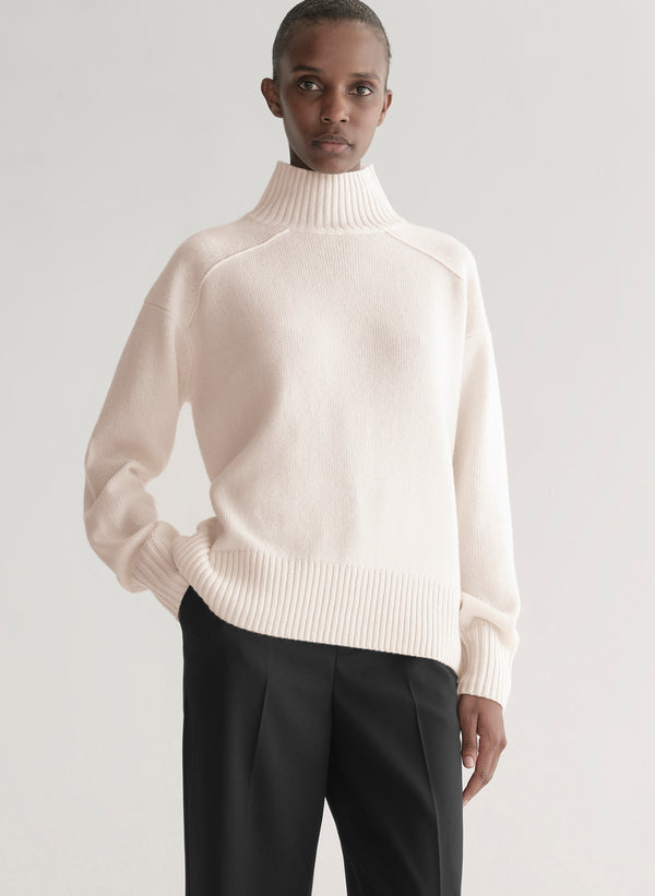 woman wearing white sweater and black pants