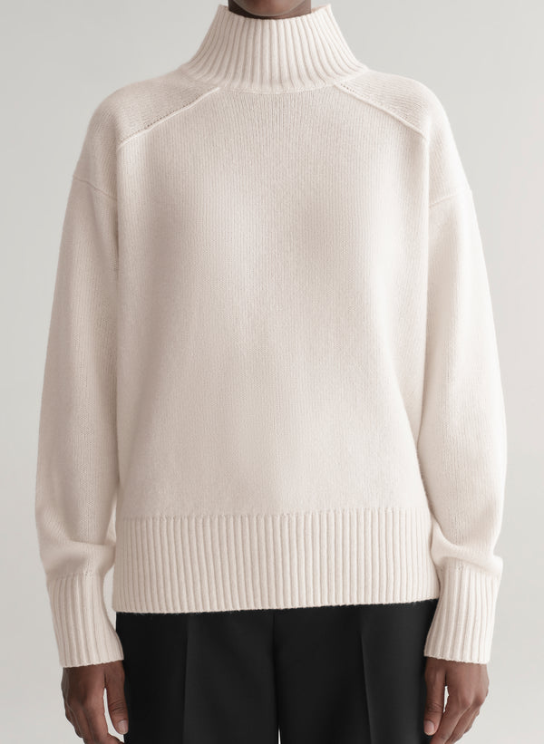 woman wearing white sweater and black pants