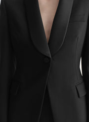 Close-up of a black suit jacket with a button
