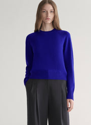 woman wearing bright blue cashmere sweater