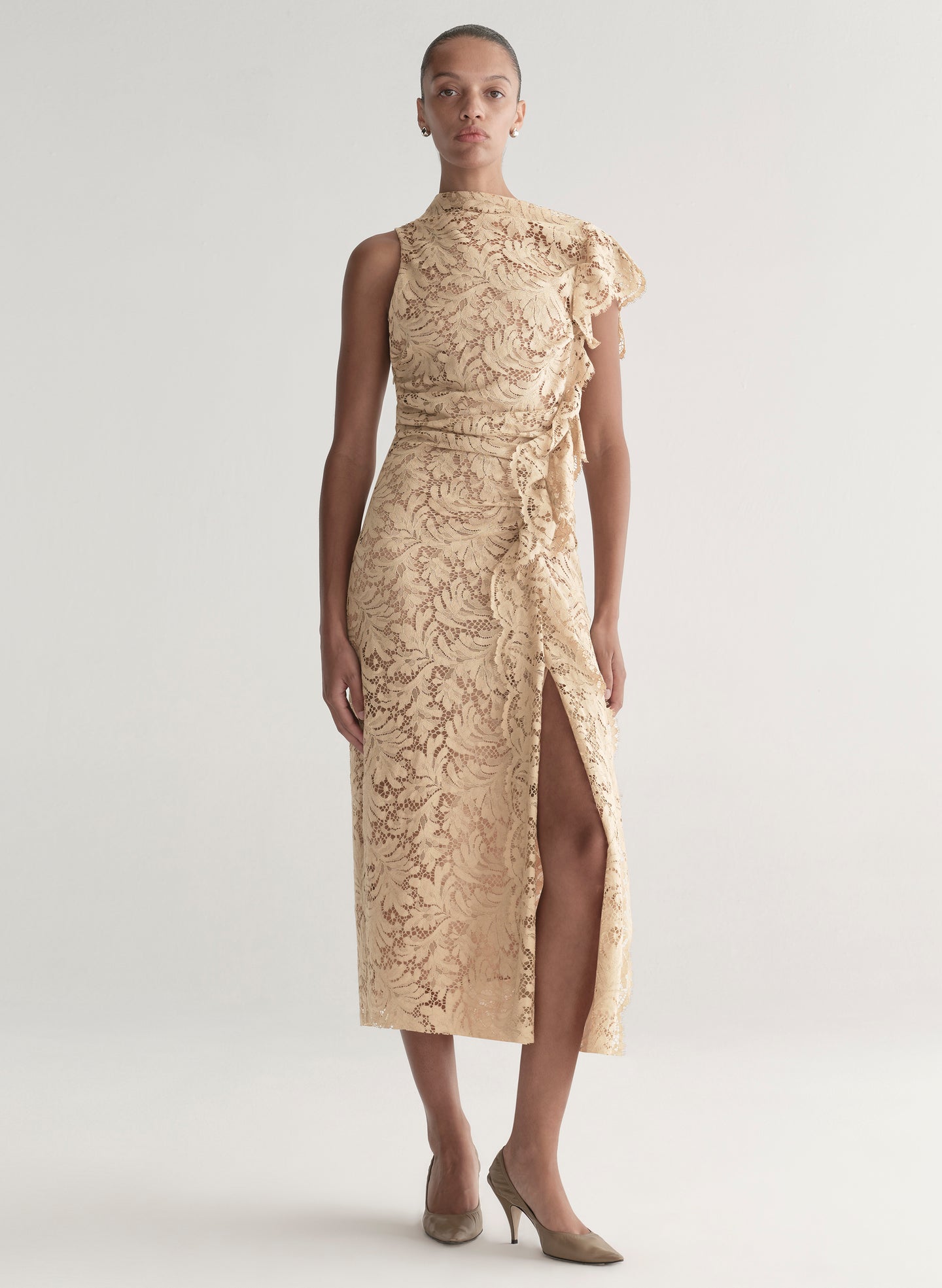Woman wearing a beige lace dress on a white background
