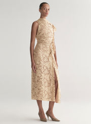 Woman wearing a beige lace dress on a white background