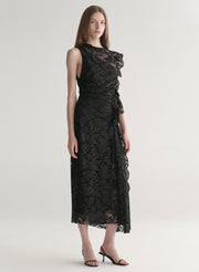 Model wearing a black lace dress on a white background