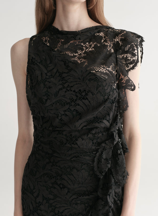 Model wearing a black lace dress on a white background