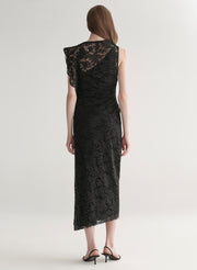 Model wearing a black lace dress on a white background