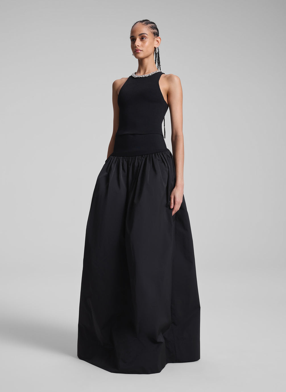 woman wearing black embellished sleeveless top and black maxi skirt