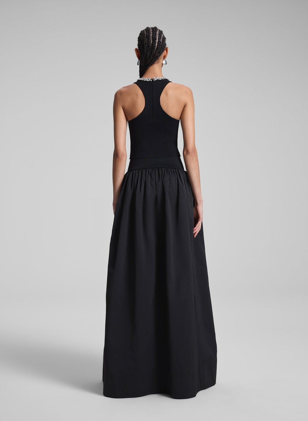 woman wearing black embellished sleeveless top and black maxi skirt