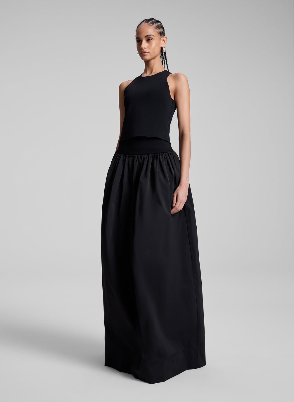 woman wearing black sleeveless top and black maxi skirt 