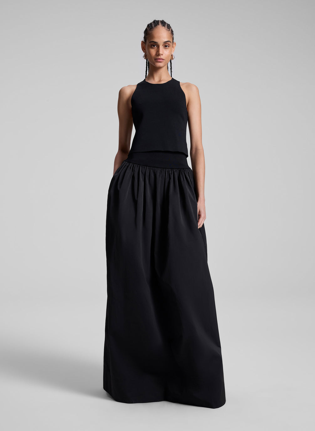 woman wearing black sleeveless top and black maxi skirt 