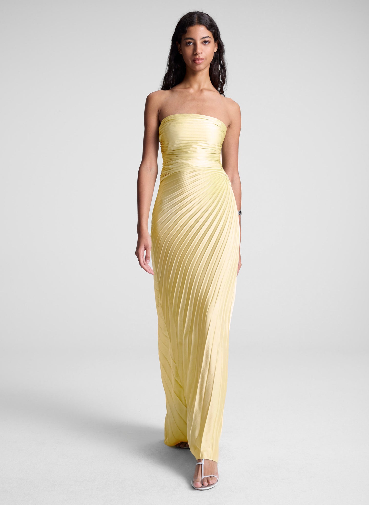 woman wearing yellow strapless pleated maxi dress