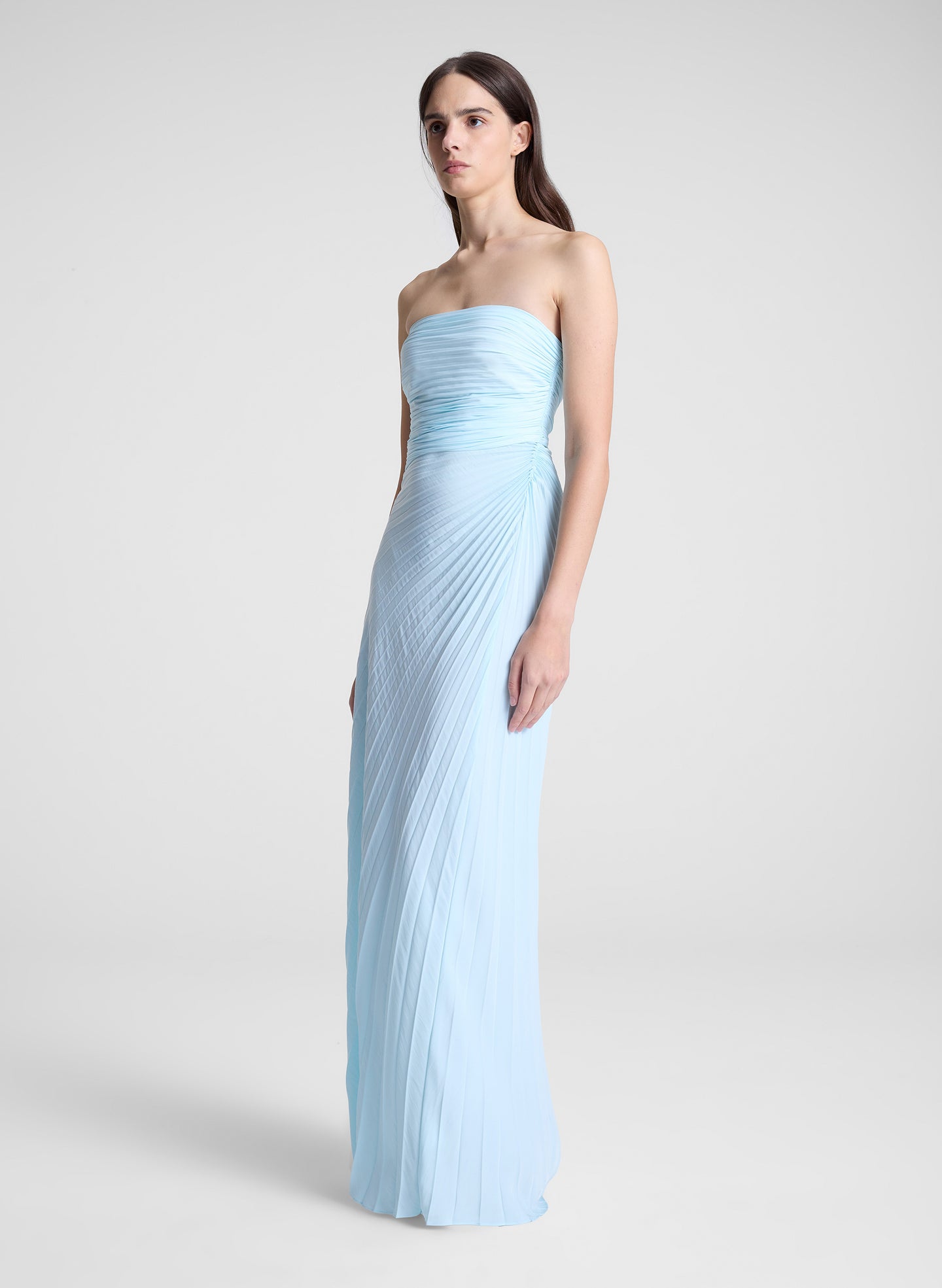 woman wearing light blue pleated strapless maxi dress