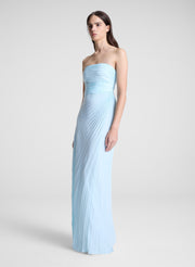 woman wearing light blue pleated strapless maxi dress