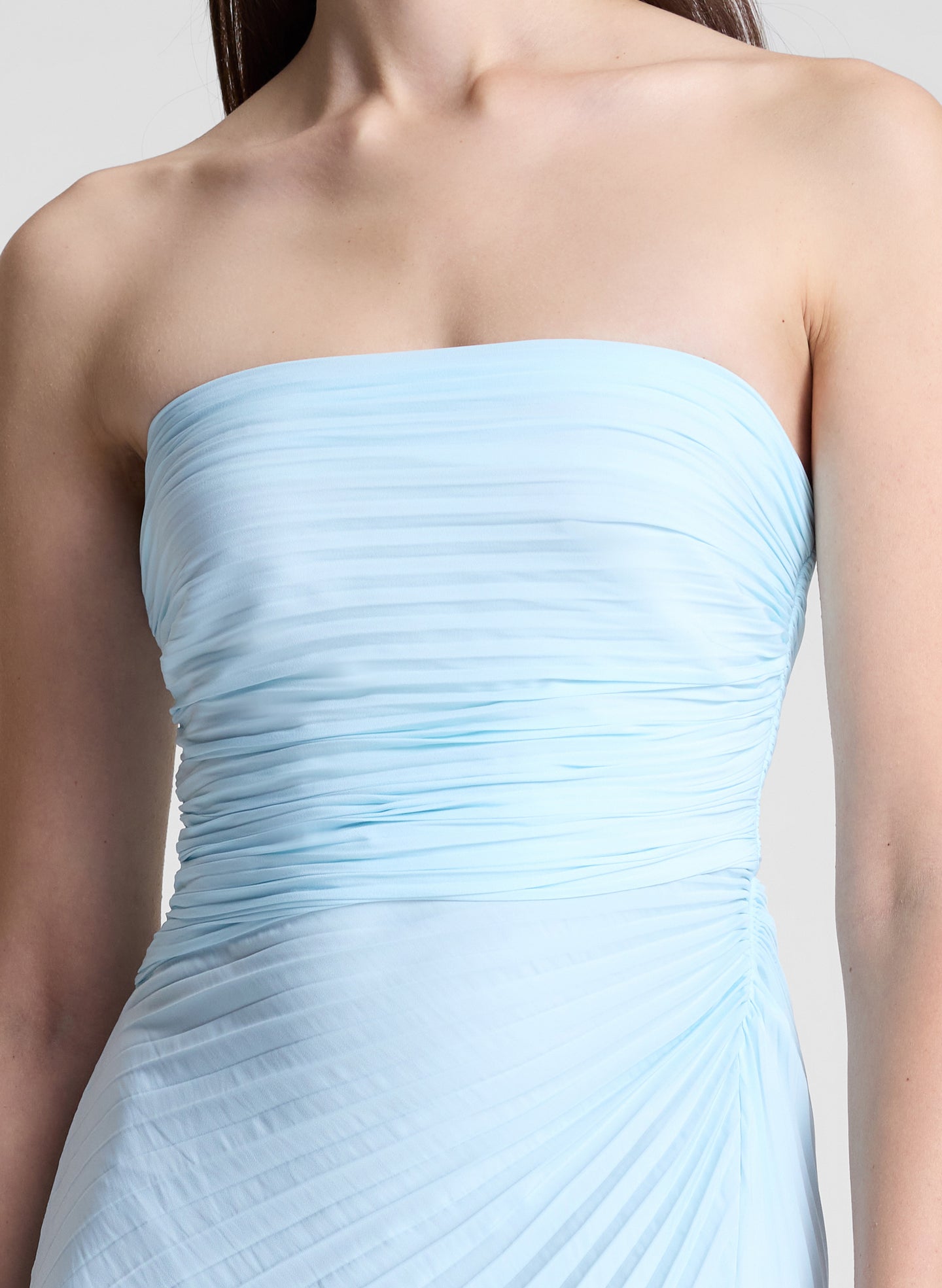 woman wearing light blue pleated strapless maxi dress