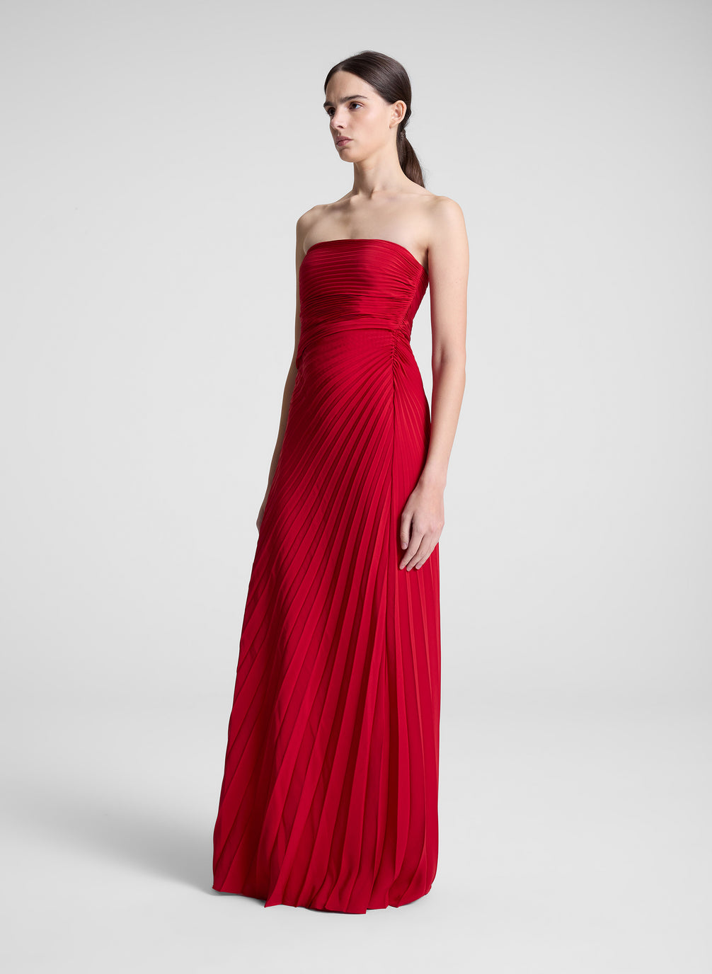 woman wearing red strapless maxi dress