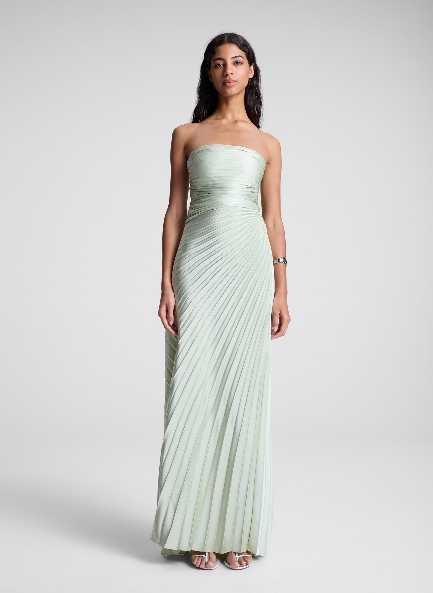 woman in light green strapless pleated maxi dress