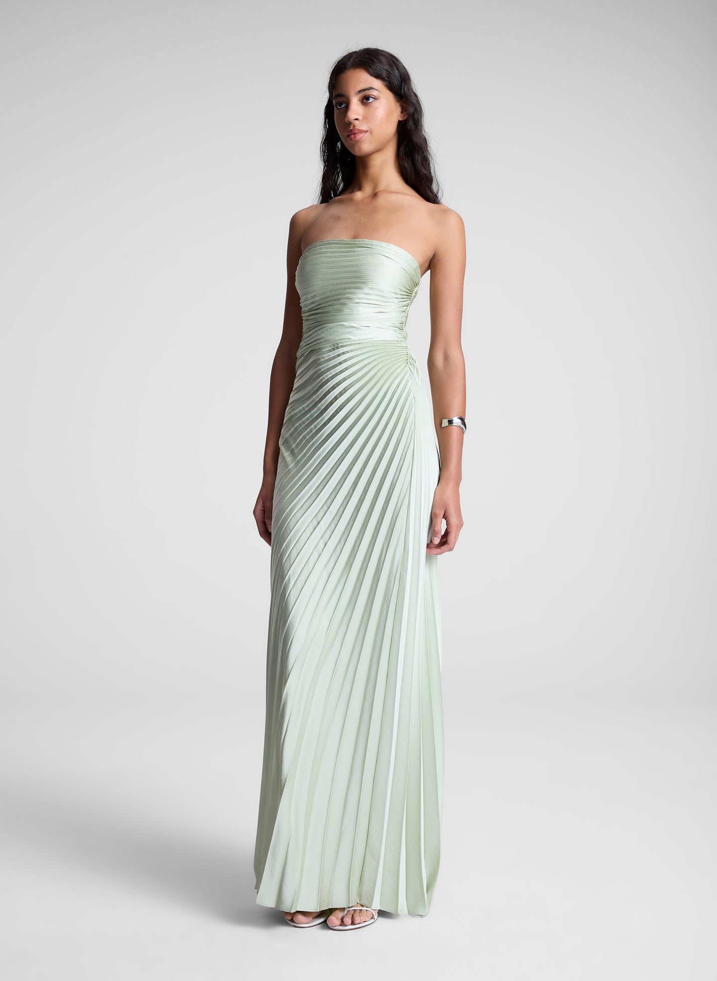 woman in light green strapless pleated maxi dress