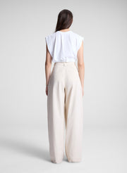 woman wearing white cropped tee and beige pants