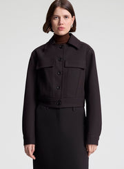 woman wearing dark brown jacket and matching skirt