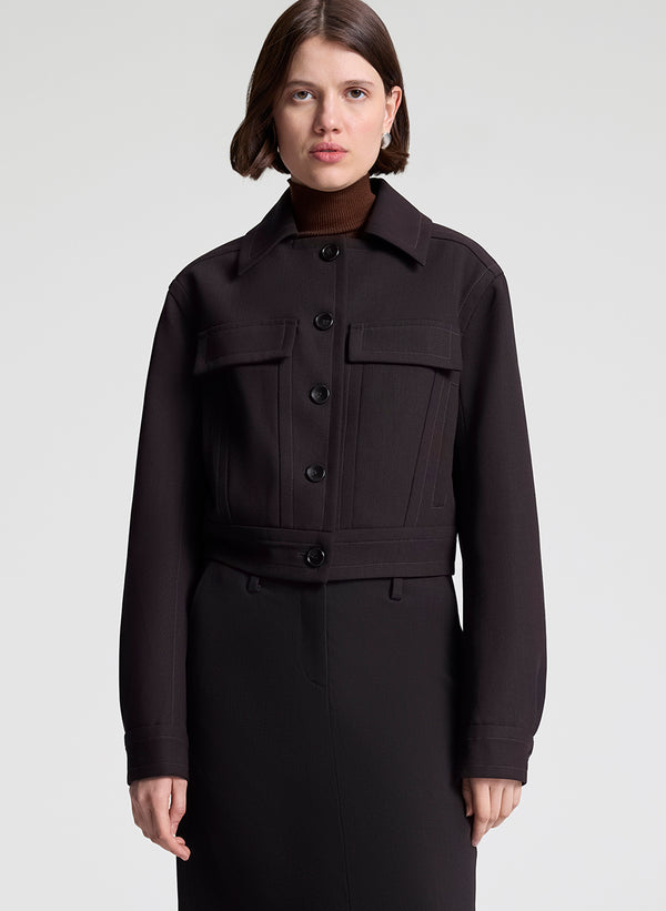 woman wearing dark brown jacket and matching skirt