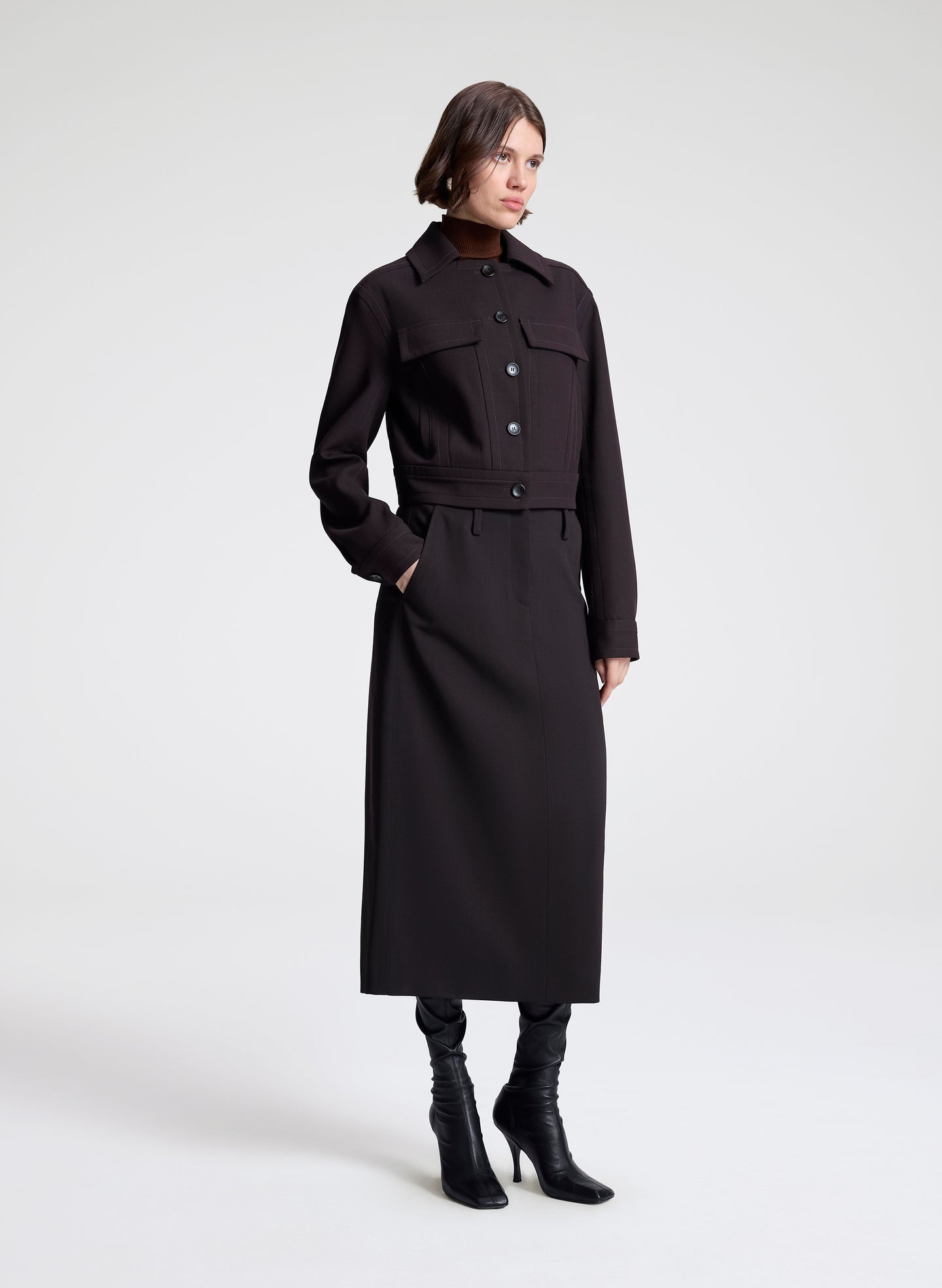 woman wearing dark brown jacket and matching skirt