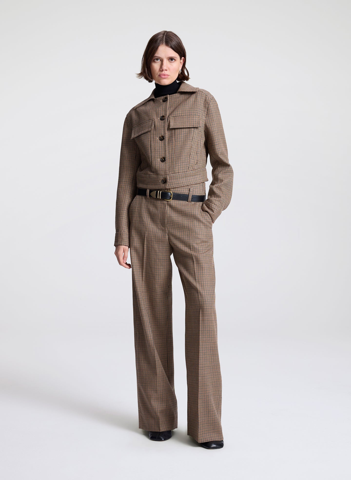 woman wearing brown plaid jacket and matching pant