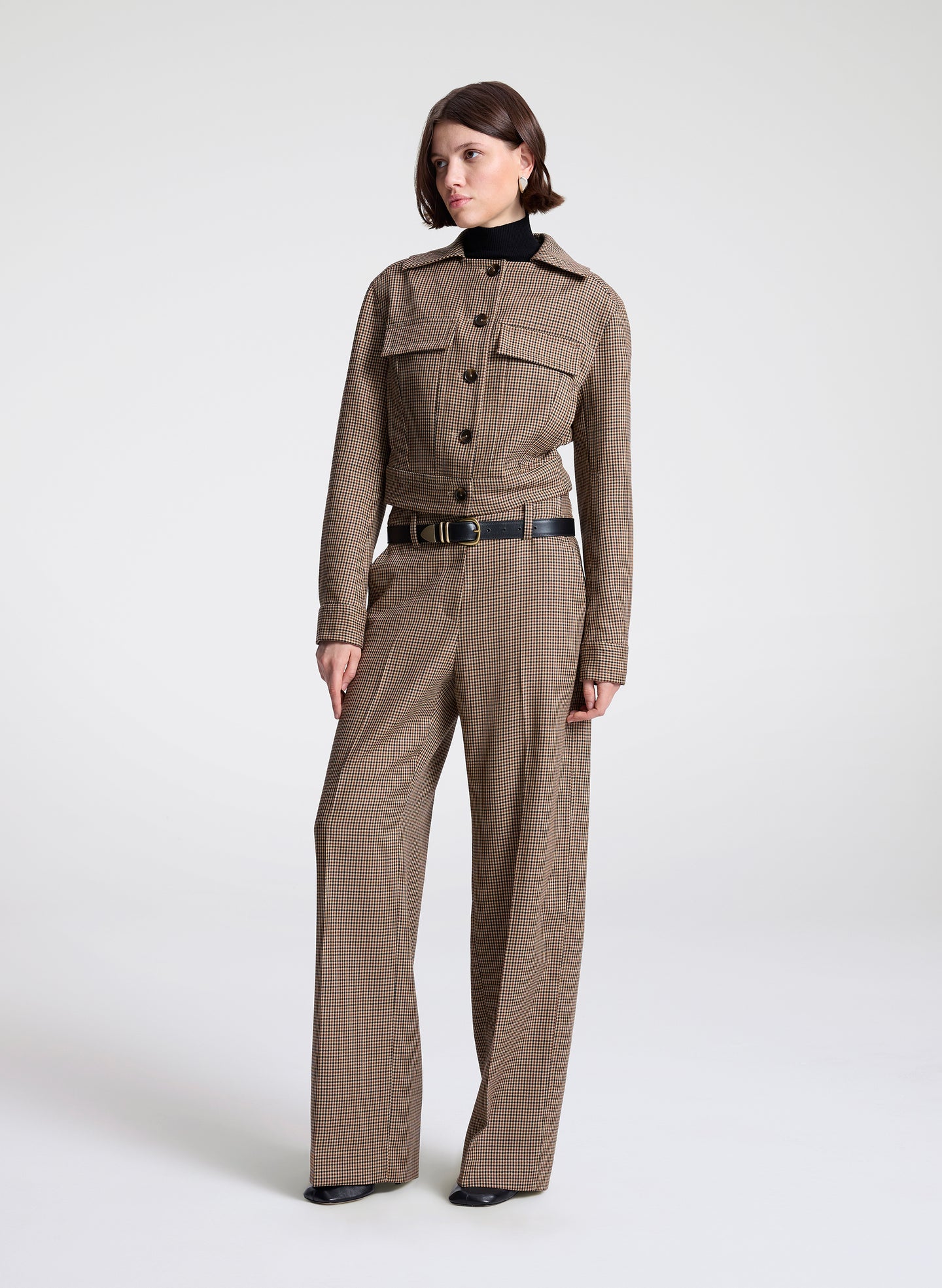 woman wearing brown plaid jacket and matching pant