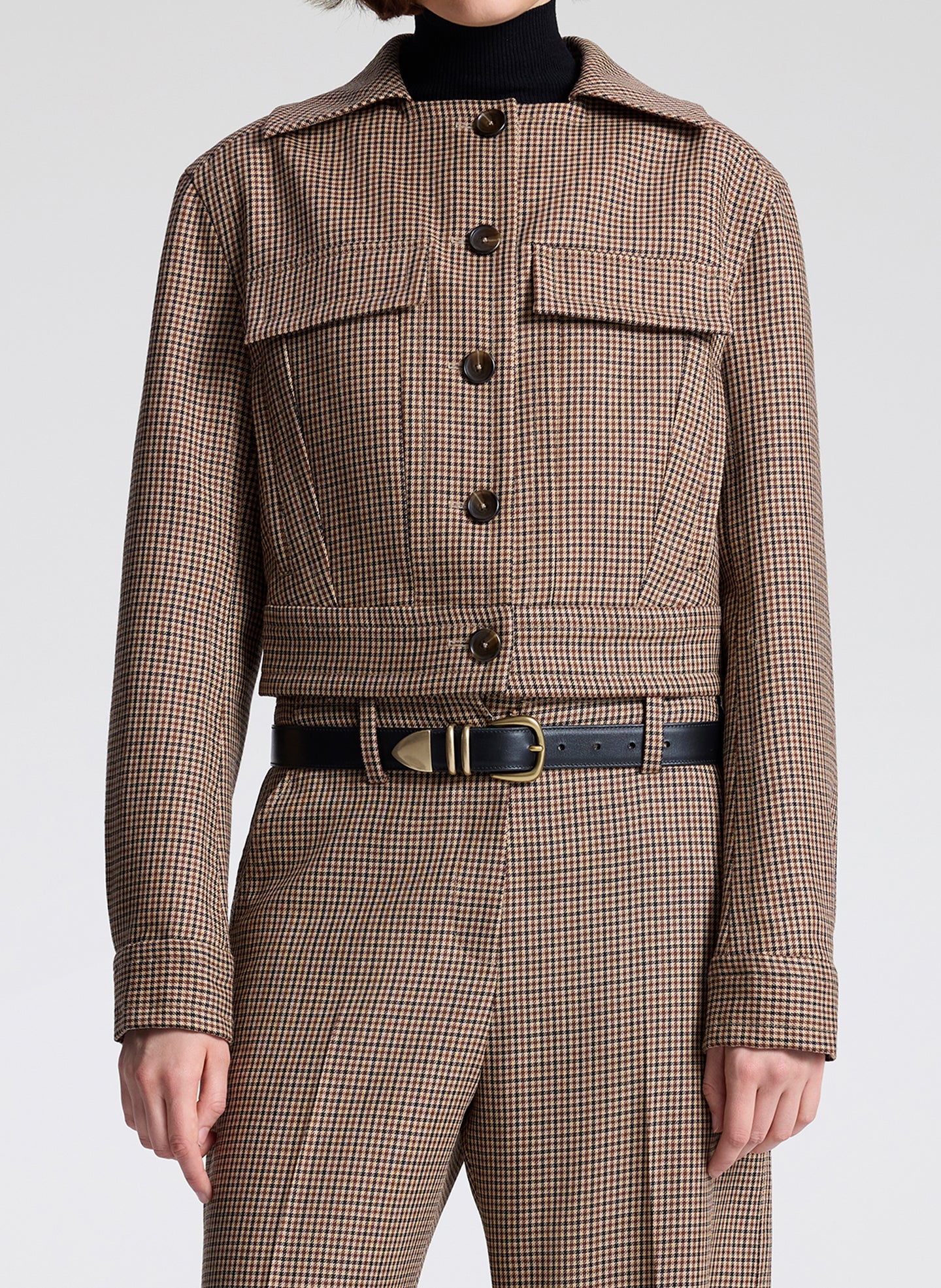 woman wearing brown plaid jacket and matching pant