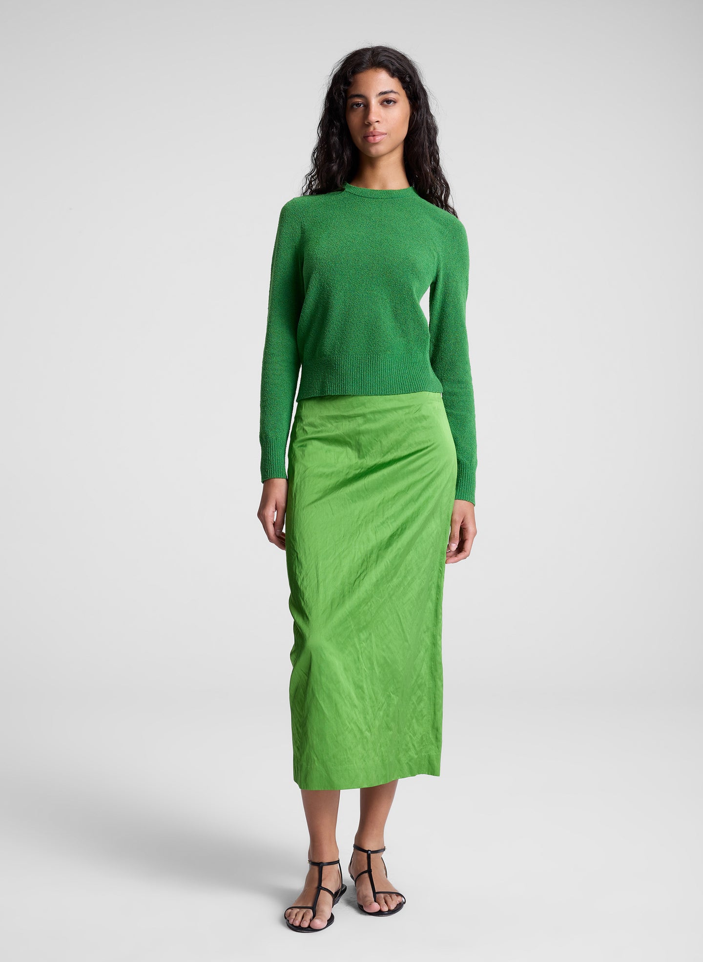 woman wearing green top and green skirt