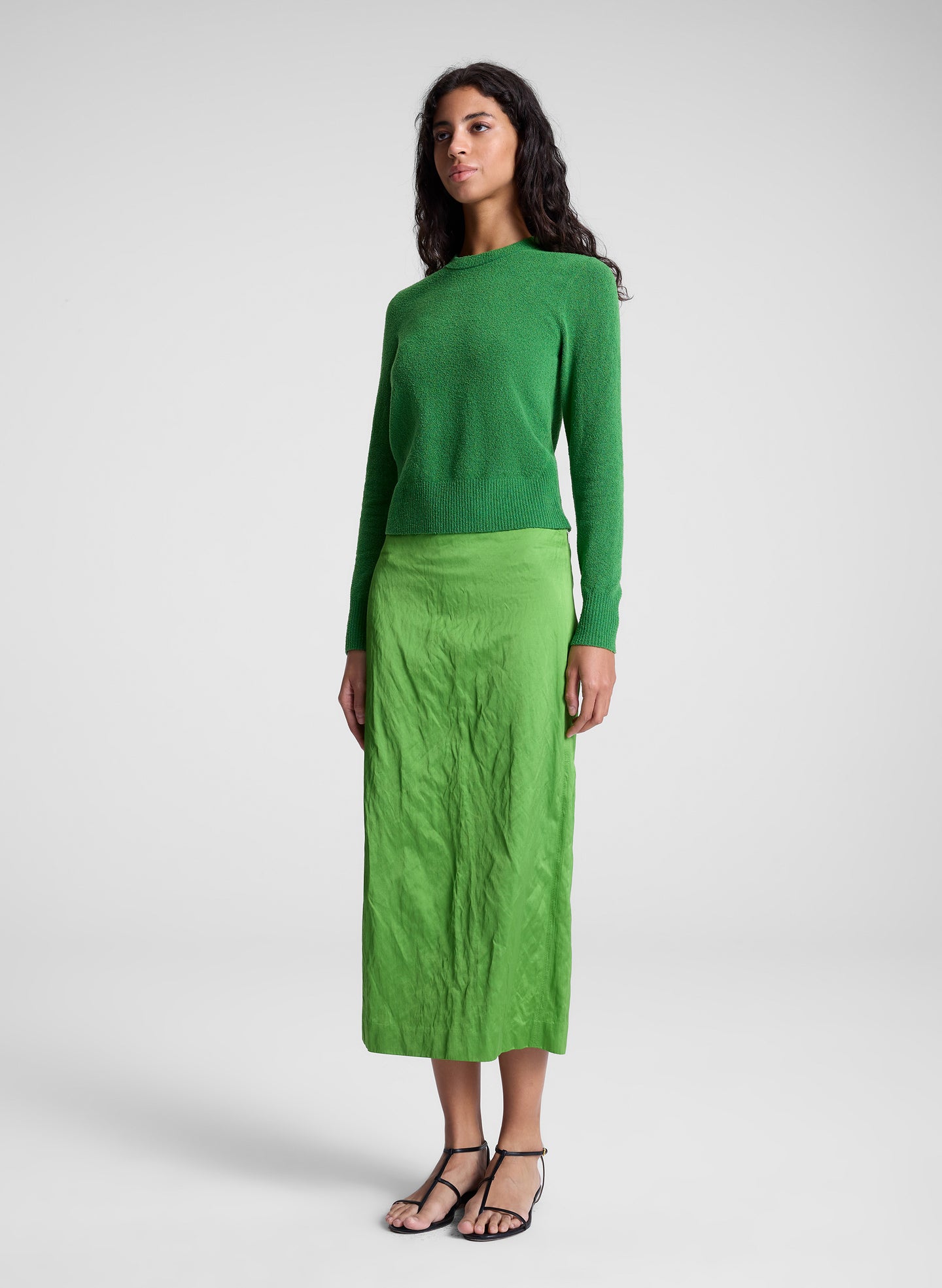 woman wearing green top and green skirt