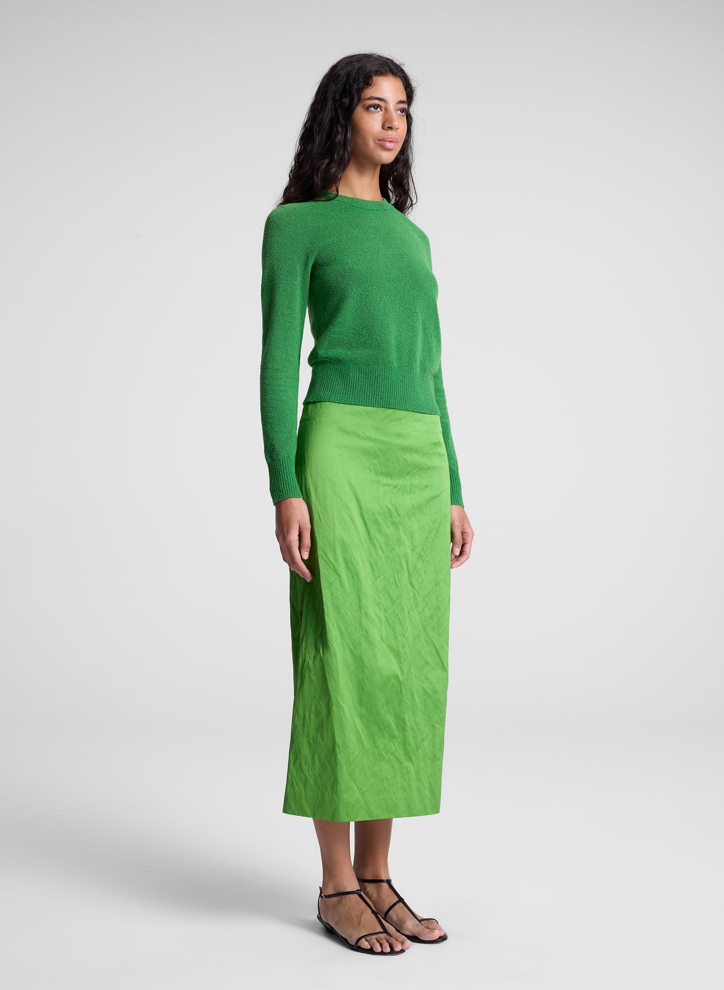 woman wearing green top and green skirt